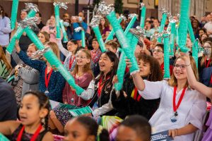 group of seated students celebrating with inflatable props